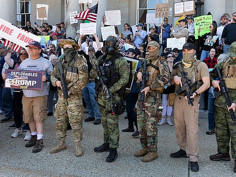 people, including those with the boogaloo movement, demonstrate against business closures due to concern about COVID-19, at the State House in Concord, New Hampshire.