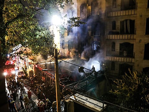First responders gather at the scene of an explosion at the Sina At'har health centre in the north of Iran's capital Tehran northern Tehran on June 30, 2020. 