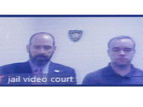 Former Atlanta police Officer Garrett Rolfe, right, appears on a television screen with attorney Lance LoRusso, Tuesday, June 30, 2020, in Atlanta.
