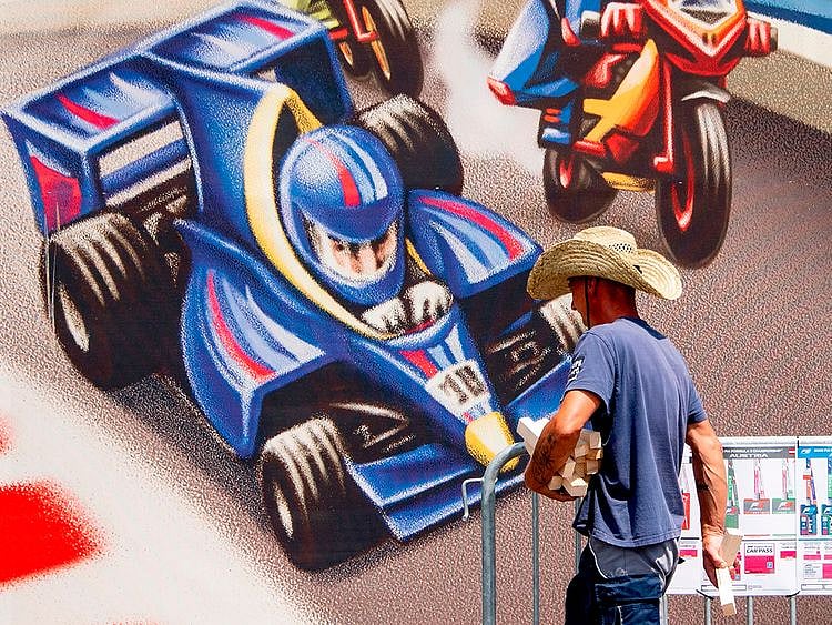 A worker with a cowboy hat at the Red Bull Ring ahead of the F1 season-opening Austrian Grand Prix in Spielberg