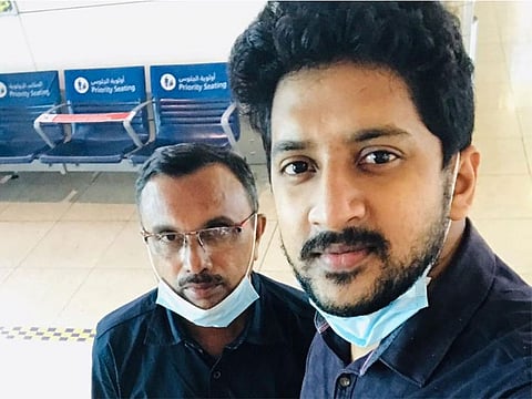 P. Shajahan (left) with KMCC volunteer Alamsha Latheef at the Dubai International Airport on Friday 