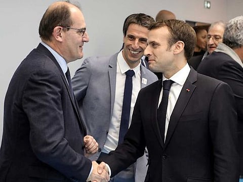 French President Emmanuel Macron shakes hands with Jean Castex (left) in Creteil, on the outskirts of Paris, on January 9, 2019. Castex replaced Edouard Philippe as prime minister.