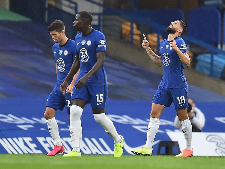 Chelsea's Olivier Giroud, right, celebrates after scoring his side's opening goal during the English Premier League soccer match between Chelsea and Watford at the Stamford Bridge stadium in London, Saturday, July 4, 2020. (Glynn Kirk/Pool via AP)