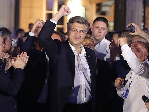Andrej Plenkovic, Croatia's Prime Minister incumbent, center, celebrates with his party members in Zagreb, Croatia, Sunday, July 5, 2020. 