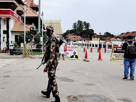  A security personnel takes guard as forces are deployed during 'Triple lockdown' in force at Thiruvananthapuram Corporation area from 6 am on Monday, July 6, 2020, for a week, in Thiruvananthapuram. 