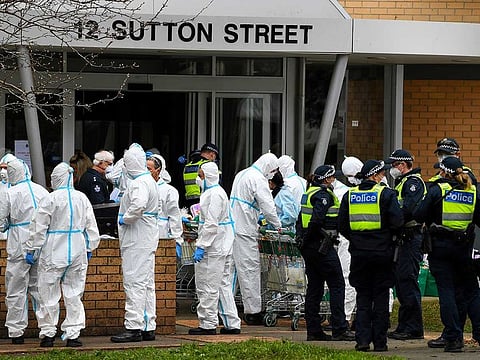 Firefighters dressed in personal protective equipment prepare to distribute food throughout a public housing tower, locked down in response to an outbreak of the coronavirus disease (COVID-19), in Melbourne, Australia, July 7, 2020. 