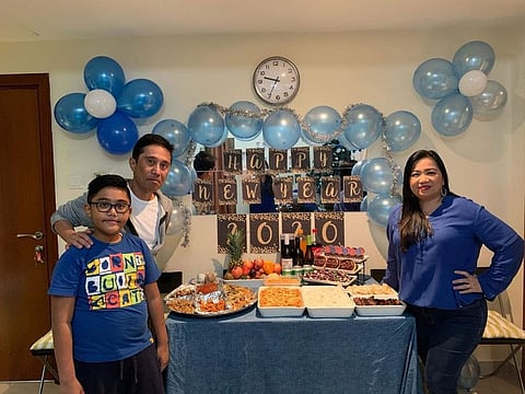 Filipina expat Grace Perfinian with her husband and son as they ushered in 2020. Little did she know then how the year would pan out. 