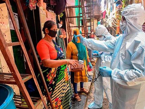  In this picture taken on June 24, 2020, medical staff wearing personal protective equipment (PPE) conduct a door-to-door medical screening inside the Dharavi slums to fight against the spread of the COVID-19 coronavirus in Mumbai.
