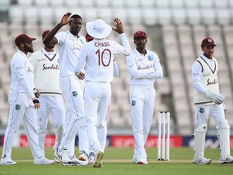 West Indies captain Jason Holder (third left) celebrates with teammates the dismissal of England captain Ben Stokes during the fourth day of the first Test match at the Ageas Bowl in Southampton, England on Saturday.