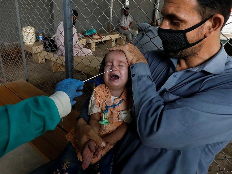 A paramedic wearing protective gloves takes a nasal swab karachi Pakistan
