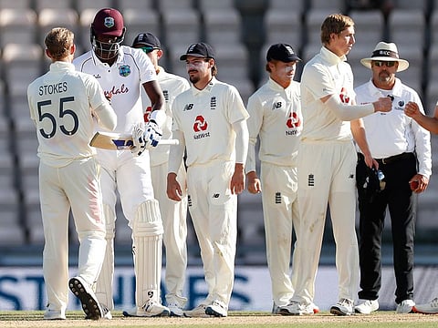 West Indies captain Jason Holder, second left, greets England captain Ben Stokes, left, after winning the first cricket Test match between England and West Indies, at the Ageas Bowl in Southampton, England, Sunday, July 12, 2020.