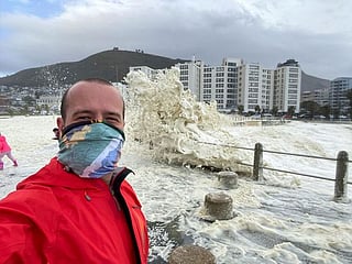 In pictures: Huge stormy sea foam drenches onlookers in South Africa's Cape Town