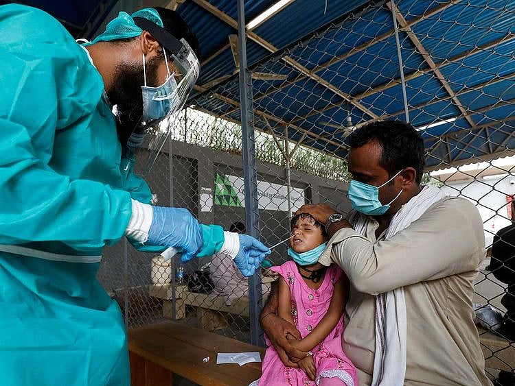 Nasal swab child Pakistan coronavirus protective gear
