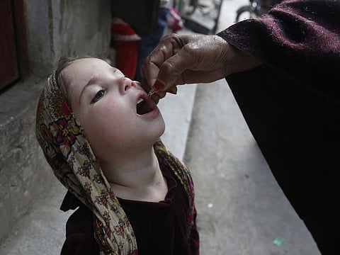 A health worker gives a polio vaccine to a child in Lahore, Pakistan, Monday, March 16, 2020. Pakistan government launched an anti-polio vaccination campaign in an effort to eradicate the crippling disease affected children. 