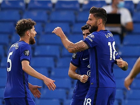 Chelsea's Olivier Giroud, right, is congratulated by teammates after scoring.