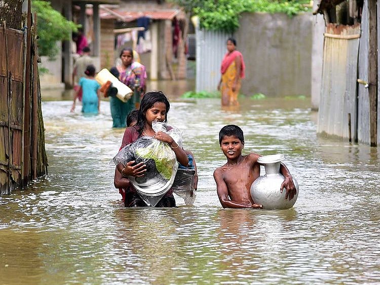 Assam flood children wade