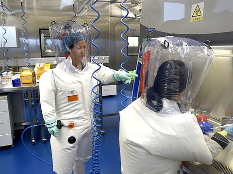In this photo taken Thursday, Feb. 23, 2017, researchers work in a lab of the Wuhan Institute of Virology in Wuhan in central China's Hubei province. Claims promoted by the Trump administration that the global coronavirus pandemic originated at the Wuhan Institute of Virology in the central Chinese city are a “pure fabrication," the institute's director said Sunday, May 24, 2020.