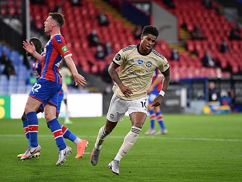 Manchester United's Marcus Rashford turns away after scoring the opening goal.