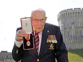 Arise Sir Tom: Queen Elizabeth knights 100-year-old fundraising captain 