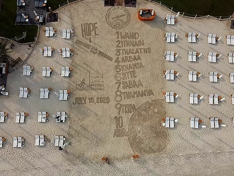 A drone-shot of Dubai-based Filipino sand artist Nathaniel Alapide, making an artistic send-off piece to the Hope Probe on the sands of the Dubai beach at Rixos Premium Dubai in JBR last Tuesday. 