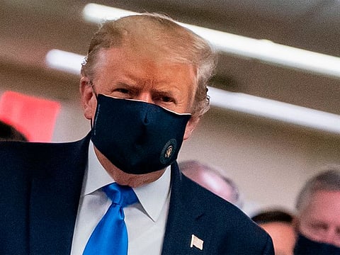 US President Donald Trump wears a mask as he visits Walter Reed National Military Medical Center in Bethesda, Maryland.