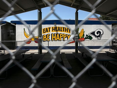 The cafeteria area of an elementary school is seen through a fence in Los Angeles. 