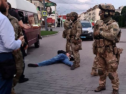 An assailant, who seized a long-distance bus with 10 hostages, lies on the ground after police officers captured him in the city centre of Lutsk, some 400 kilometers west of Kiev, Ukraine on Tuesday July 21, 2020.