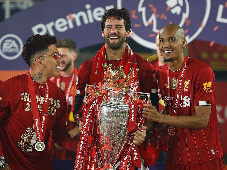 Fabinho, right, with Roberto Firmino and Alisson at the Liverpool Premier League title party.
