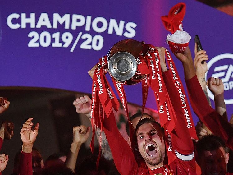 Liverpool's Jordan Henderson and teammates celebrate with the Premier League trophy
