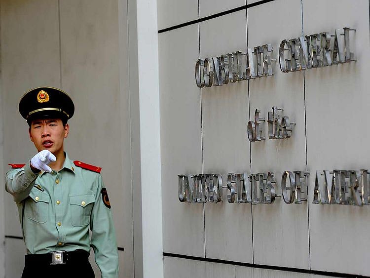 This file photo taken on September 18, 2012 shows a Chinese paramilitary policeman gesturing to photographers at the entrance to the US consulate in Chengdu, southwest China's Sichuan province.