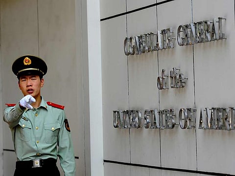 This file photo taken on September 18, 2012 shows a Chinese paramilitary policeman gesturing to photographers at the entrance to the US consulate in Chengdu, southwest China's Sichuan province.