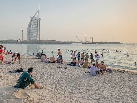 People throng the Jumeirah public beach in Dubai after restrictions were eased.