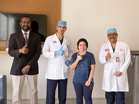 From left: Dr Tarig Mohamed El Hassan, Dr Trilok Chand and Dr Sivan Pillay, with Shanne Camille Francisco after recovery.
