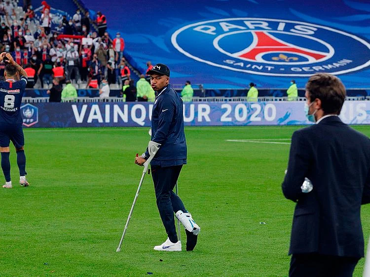 Paris St-Germain's Kylian Mbappe walks with crutches after the French Cup final win over St-Etienne