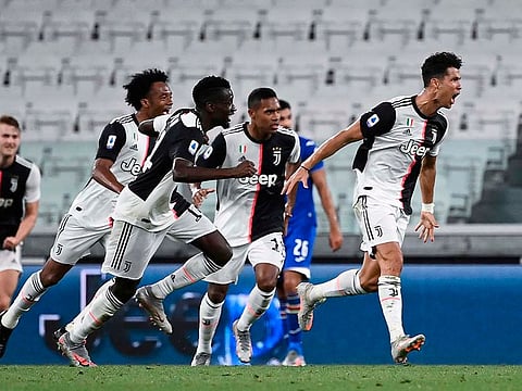 Cristiano Ronaldo (R) celebrates after scoring.
