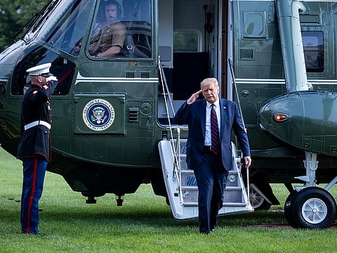 US President Donald Trump salutes as he departs Marine One at the White House in Washington, Monday, July 27, 2020, following a trip to Morrisville, N.C., where he toured the Bioprocess Innovation Center at Fujifilm Diosynth Biotechnologies.