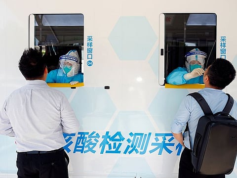 File photo: Two people are tested at the windows of a testing vehicle, following a new outbreak of the coronavirus disease (COVID-19) in Beijing, China, June 30, 2020.