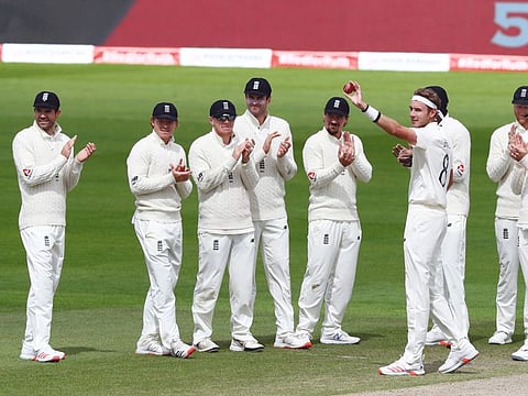 England's Stuart Broad shows off the ball with which he took the 500th Test wicket with teammates after taking the wicket of West Indies' Kraigg Brathwaite on the final day of the third Test match on Tuesday. James Anderson, with whom he shares a phenomenal partnership, is seen on extreme left.