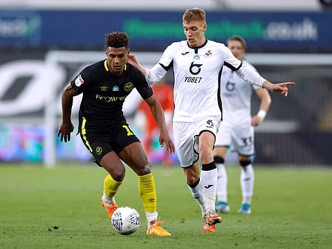 Brentford's Ollie Watkins (left) tries to shrug off Swansea City's Jay Fulton in their Championship play-off semi-final match on Wednesday. Brentford won 3-2 on aggregate.