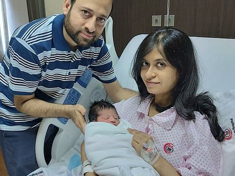 Ambareen Tariq and her husband with their baby.