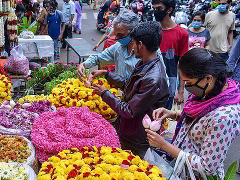 People shop for flowers at a market in Bangalore, India, on July 29, 2020.