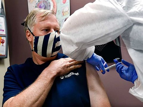 A volunteer  receives an injection as the world's biggest study of a possible COVID-19 vaccine, developed by the National Institutes of Health and Moderna Inc., got underway on July 27, 2020, in Binghamton, New York, US.