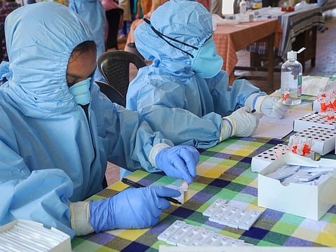 Health workers prepare to collect swab samples for COVID-19 tests, at an office in Kozhikode, Tuesday, July 21, 2020.
