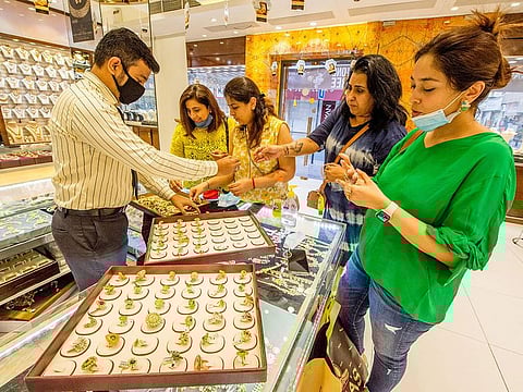 Gold jewellery sales at a store in Dubai. Prices sank below $1,900 an ounce on Tuesday, extending the precious metal's slump into a second day after the haven lost more than 5% in the week's opening session.