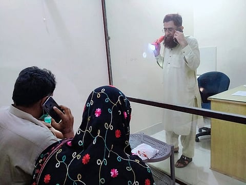 Dr. Zafar Ehsan has split his clinic in Punjab’s southern district Layyah into two halves via a glass wall to create a virus-free facility. 