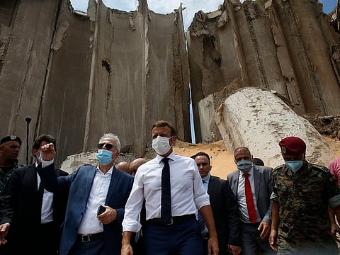 French President Emmanuel Macron visits the devastated site of the explosion at the port of Beirut, Lebanon, Thursday August 6, 2020. Macron arrived in Beirut to offer French support to Lebanon after the deadly port blast.