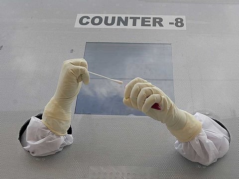 A health worker prepares to collect nasal swab samples for COVID-19 tests at a mobile testing centre in India. Picture used for illustrative purposes only.