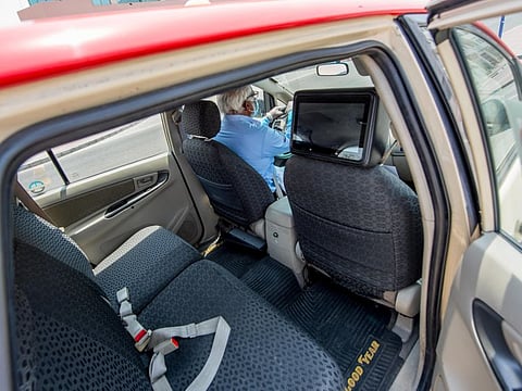 A Dubai Taxi Driver in Al Garhoud. Dubai Taxi has started removing the plastic protection between driver and passengers. 