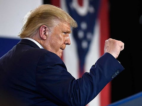 President Donald Trump pumps his fist as he finishes speaking during an event at the Whirlpool Corporation facility in Clyde, Ohio, Thursday, Aug. 6, 2020. 