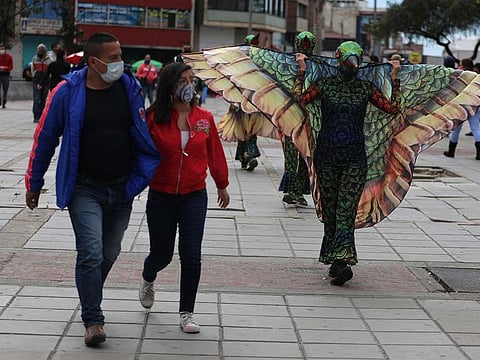 Actors dressed as hummingbirds walk the streets, flapping their wings during a mayoral campaign to promote social distancing, amidst an outbreak of the coronavirus disease (COVID-19), in Bogota, Colombia August 6, 2020. 